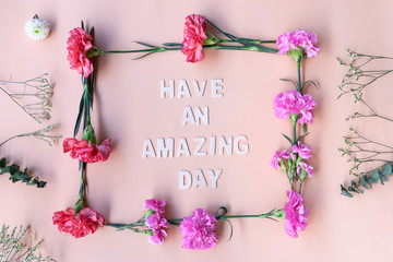 Minimal flat lay  you are amazing inspiration wooden word with fresh flowers  frame