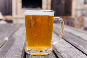 Glass of a tasty home made beer on table