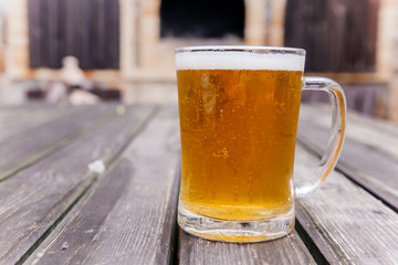 Glass of a tasty home made beer on table