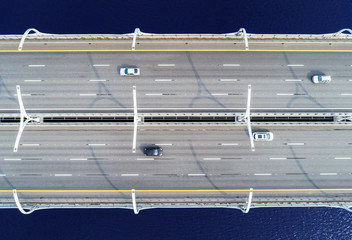 Aerial view of highway in the ocean. Cars crossing bridge interchange overpass. Highway interchange...