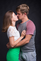 Lovers kissing each other on black background