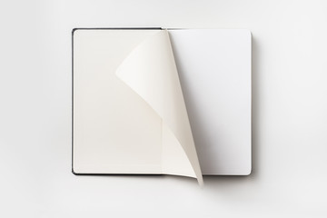 Top view of black notebook with curl rolled page
