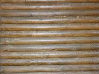 Wall of brown wooden logs
