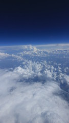 Вид из окна самолёта. Облака. Земля.