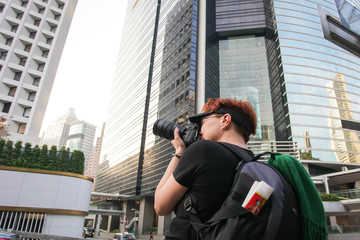 photographer take photo of city. red-haired woman taking pictures of Hong Kong