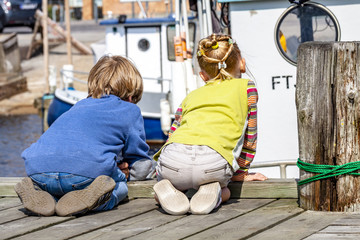 Brother and sister enjoying their vacation in the harbour