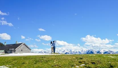 Obraz premium Young Asian couple stand at edge of Schafberg mountain (the mountain in movie 'sound of music'), Austria, looking far away