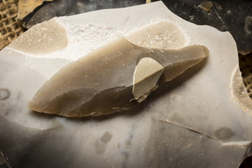  an arrowhead made from flintstone close up - experimental archeology