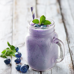 Blueberry smoothies juice a tasty healthy drink in a glass jar, drink the morning on white wooden...