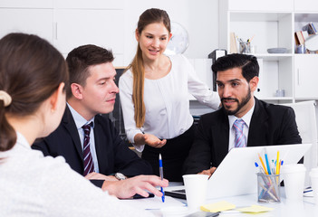 Fototapeta premium Business woman with partners in office