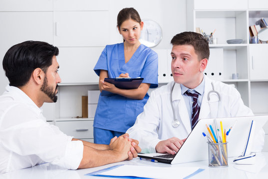 Doctor listening to patient complaints at clinic