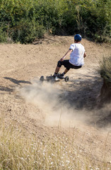 Mountainboard rider during downhill in mountainboard park