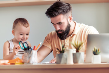 Adorable kid drawing with father