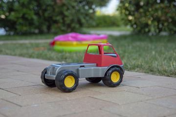 red children's car on the grass