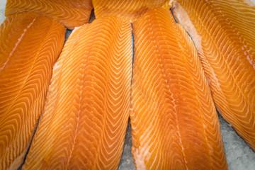 Red fish fillets on ice close-up
