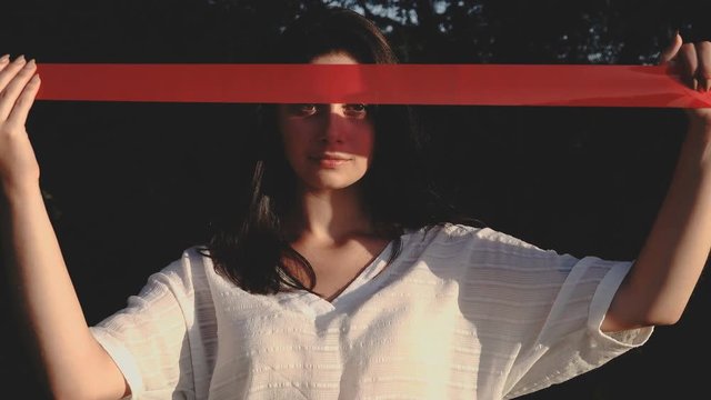 Conceptual Video Girl Raises In Front Of A Red Masking Tape.