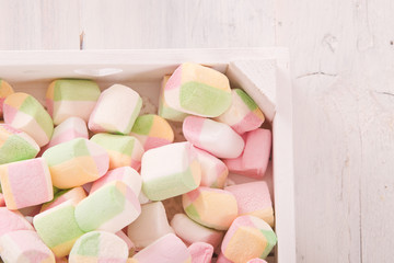 Marshmallows on wooden table.