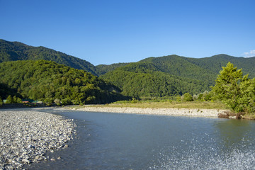 mountain river on a background of mountains and blue sky