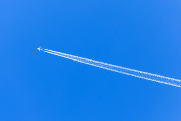White aircraft big two engines aviation airport contrail clouds.