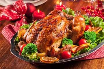 Baked or roasted whole chicken on Christmas table