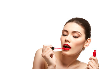 Fototapeta premium girl applying red lipstick isolated on white