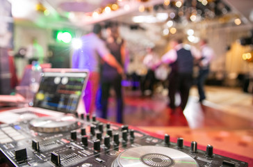 Fototapeta na wymiar The disco, Banquet, people blurred background dancing. Dj panel 