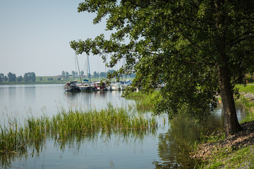 Fototapeta na wymiar Marina and pier on Rynskie lake, town of Ryn.