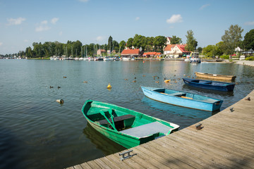 Fototapeta na wymiar Marina and pier on Rynskie lake, town of Ryn.