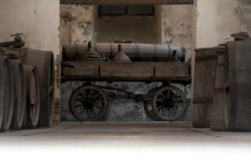 Fototapeta na wymiar old wine barrel cellar with original cart