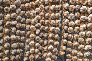 rope with garlic at the market stall