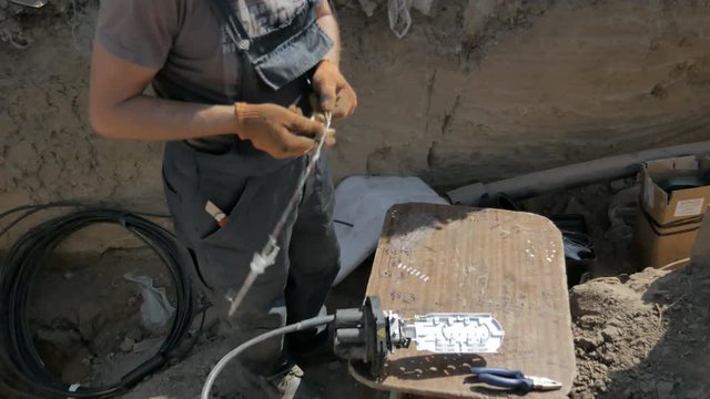 Telecommunications engineer working with optical coupling