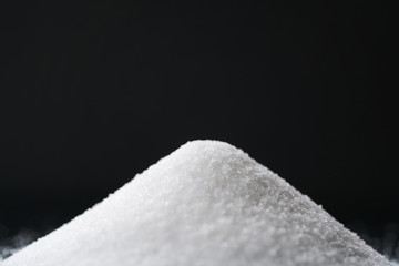 white sugar on black background