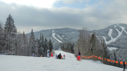 Fototapeta premium Skiers on a ski track on a beautiful sunny day in the Alps