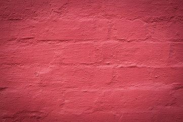 wall of brick painted red background. texture, vignette.