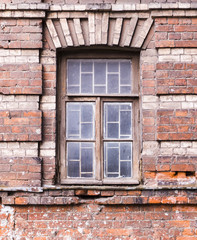 old cracked brick wall with a window. architecture, details.