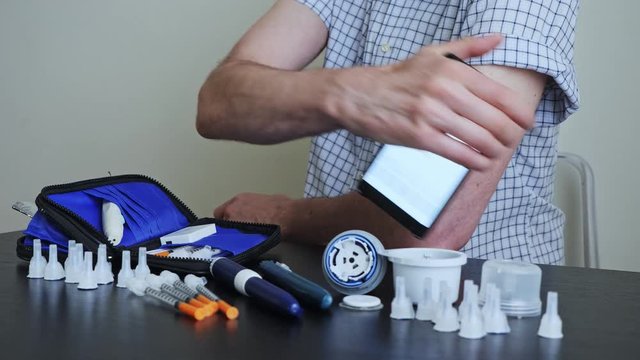 A man hands brings to the hand the smartphone for measuring glucose in the blood