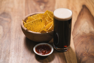 dark beer with nachos and salsa sauce