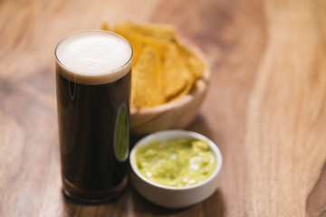 dark beer with nachos and guacamole sauce