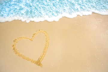 a heart in the sand on the beach.heart drawn on sand. 