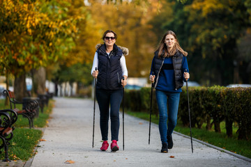 Nordic walking - active people working out in park