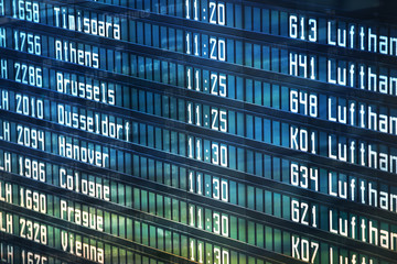 Flights information departures board in airport terminal.