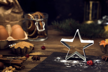 Winter (Christmas) baking ingredients on dark rustic background.