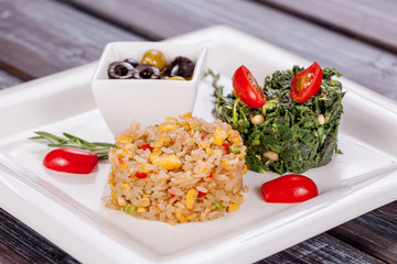Vegetarian rice dish with vegetables and spinach stewed with nuts