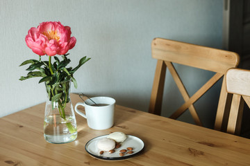  Sweets, flower and tea. Snack on a wooden table. Girls' favorite food and flowers.