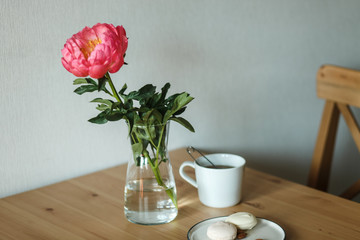  Sweets, flower and tea. Snack on a wooden table. Girls' favorite food and flowers.