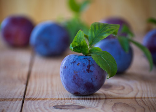 Fresh delicious plum on a wooden table
