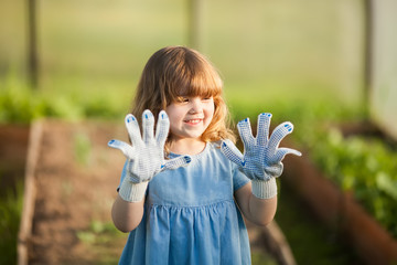 Adorable little girl in the greenhouse
