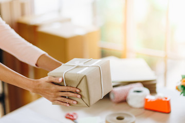 Woman hands delivery a parcel box , Ideas about e-commerce