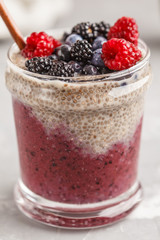 Berry smoothie and chia pudding for breakfast in a glass.