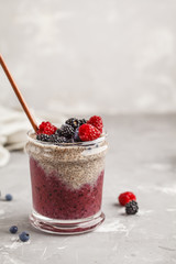 Berry smoothie and chia pudding for breakfast in a glass.